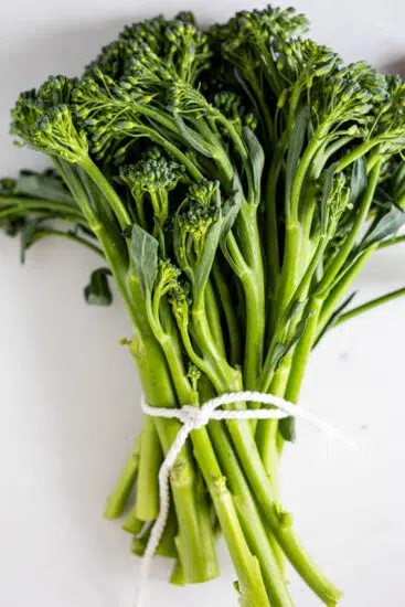 Broccolini tied in a bunch.