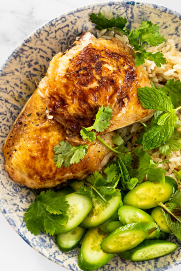 One pan ginger chicken and rice served with soy dressing, cucumber and fresh herbs.