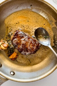 Steak basted with butter.