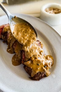 Sauce poured over steak.