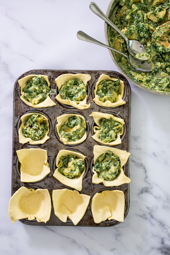 Puff pastry filled with cheesy spinach artichoke filling.
