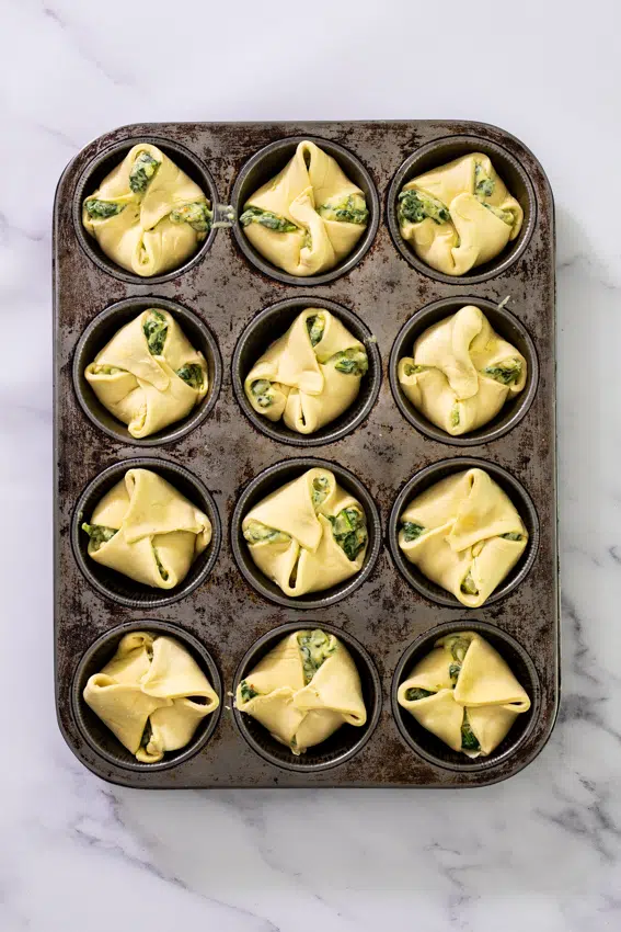 Pastry puffs with spinach artichoke filling.
