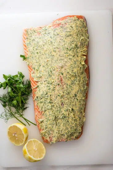 Side of salmon rubbed with garlic herb butter.