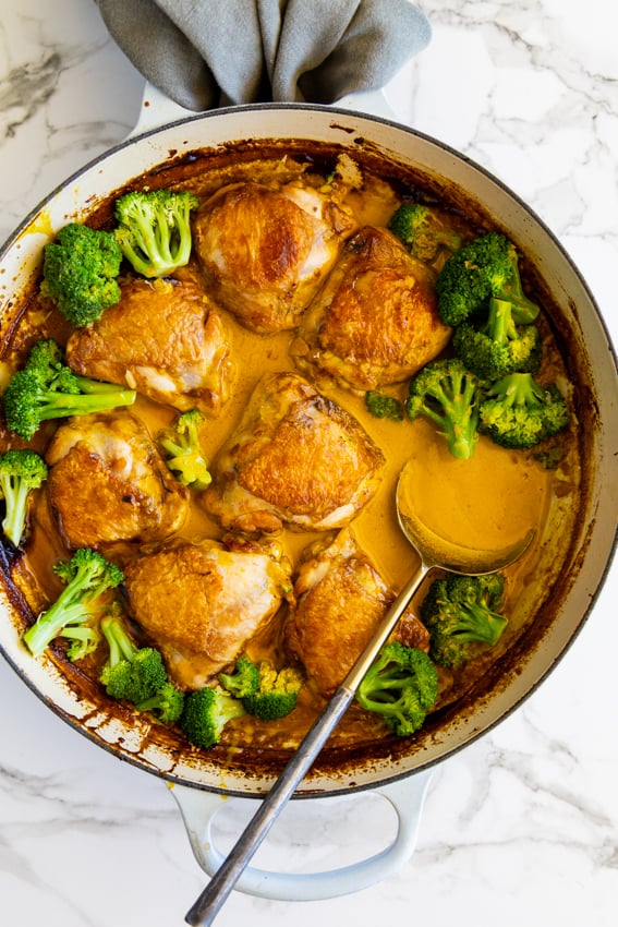 Coconut Curry Chicken Thighs with broccoli in pan.