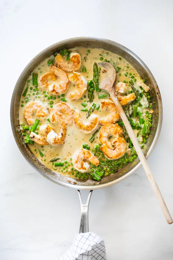 Shrimp and spring vegetables in creamy lemon sauce.