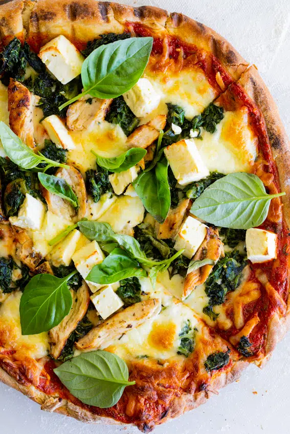 Grilled Greek chicken pizza with feta and spinach.