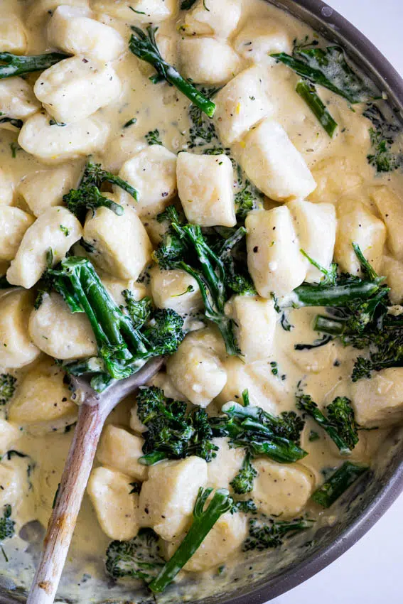 Light and fluffy ricotta gnocchi in creamy lemon broccoli sauce.