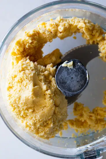 Cheddar Apricot Thumbprint cookies dough in food processor.