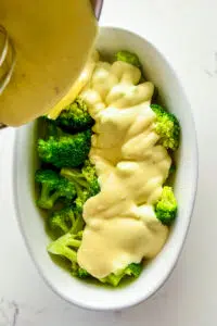 Cheese sauce poured over broccoli.