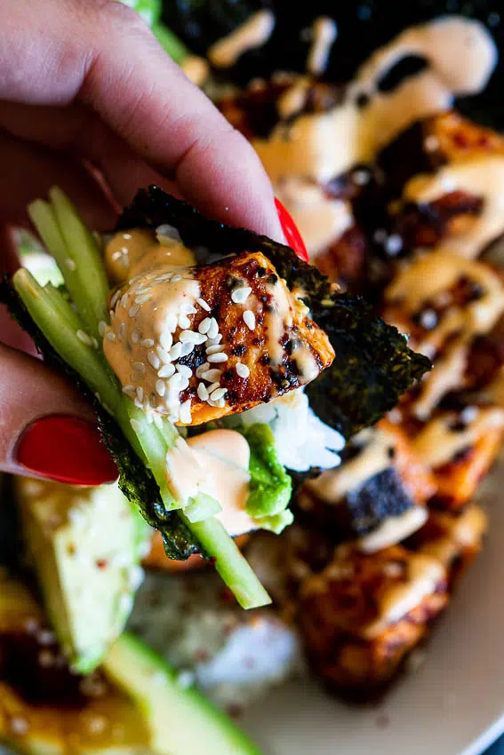 Spicy salmon rice bowl with spicy mayo, roasted seaweed and sushi rice.