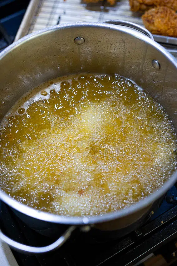 Chicken frying in oil.