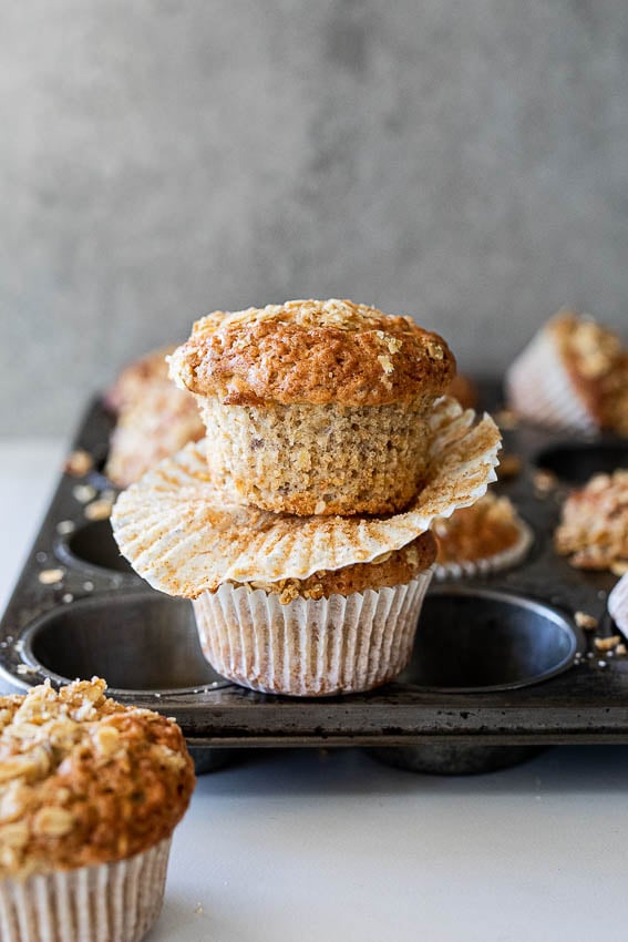 Fluffy, moist banana oatmeal muffins in a muffin tray.