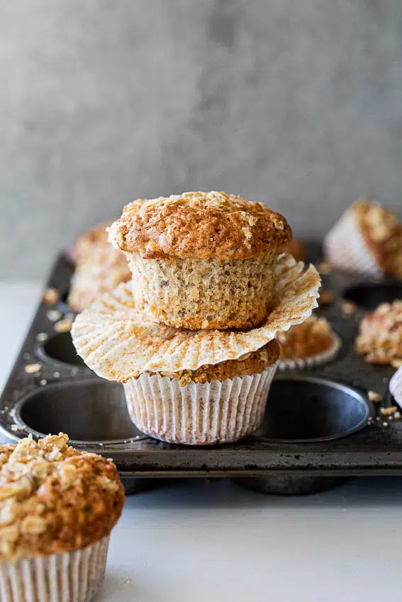 Fluffy, moist banana oatmeal muffins in a muffin tray.