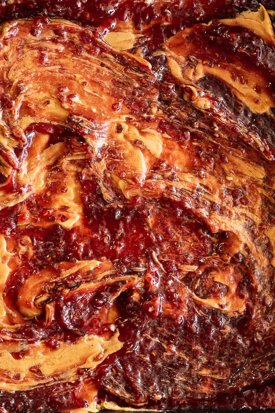 Peanut butter swirled with raspberry jam.