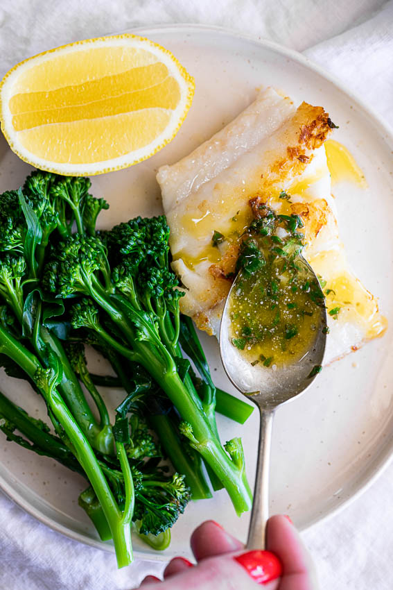 Garlic butter sauce with fish and broccolini