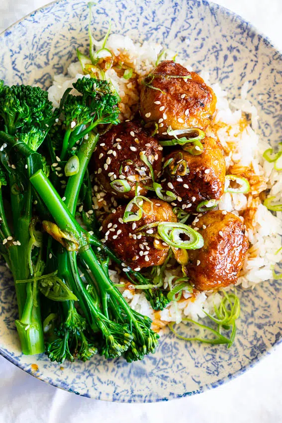 Honey Sriracha chicken meatballs with rice and broccolini