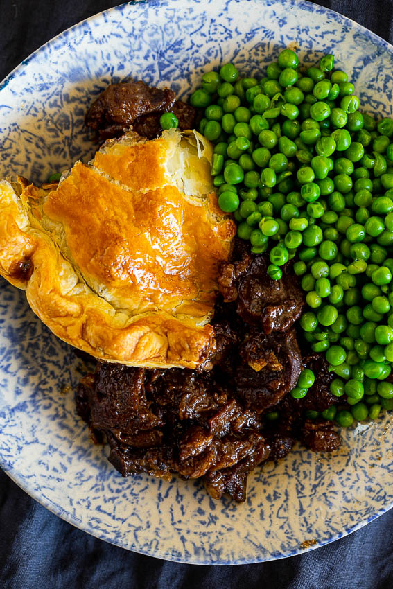 Steak and ale pie served with peas
