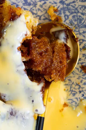 Malva pudding with custard and cream.