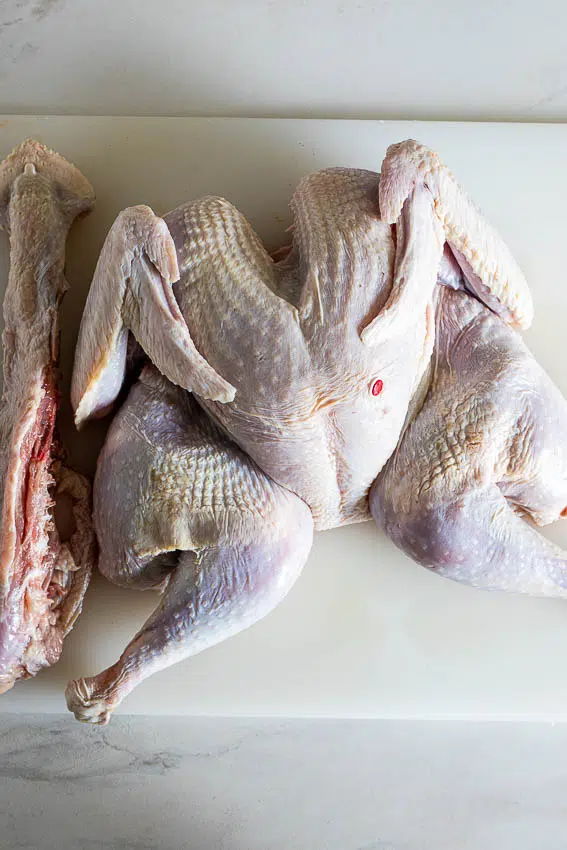 Spatchcock turkey on cutting board.