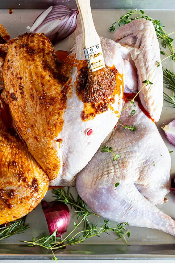 Spatchcock turkey brushed with seasoned oil.