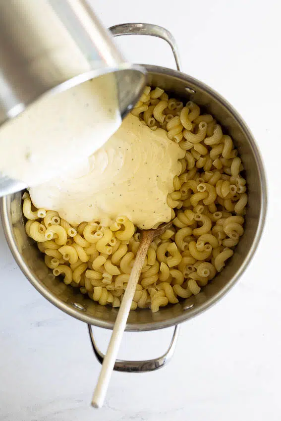 Cheese sauce poured onto cooked macaroni