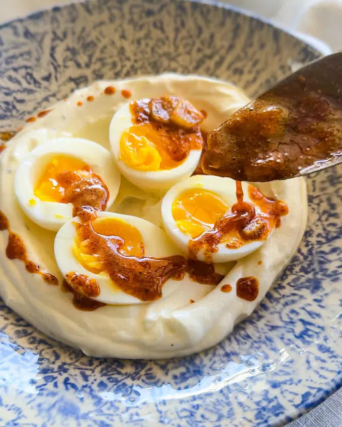 Spicy butter drizzled over Turkish Eggs.