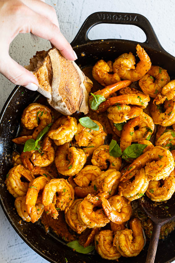 Cajun shrimp served with crusty bread.