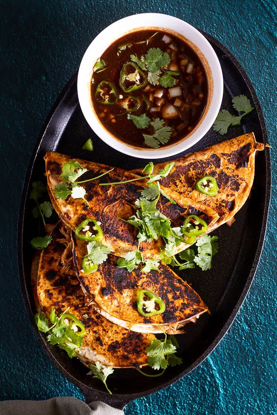 Chicken Birria Tacos served with aromatic consommé for dipping