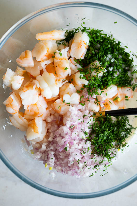 Shrimp salad mixture with red onion and fresh herbs.