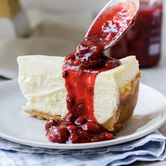 Classic lemon cheesecake with berry sauce