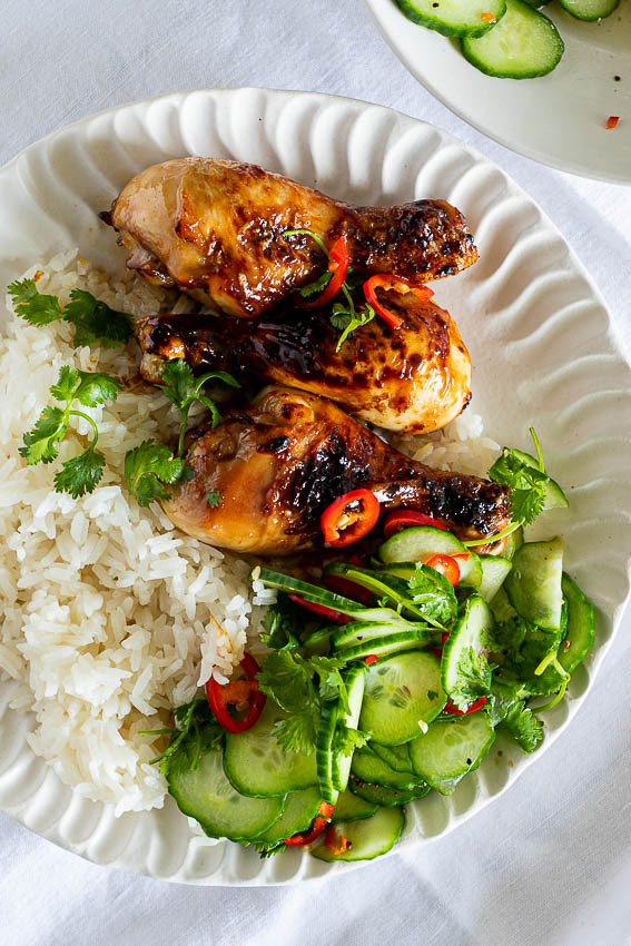 Sticky garlic air fryer chicken legs with coconut rice and spicy cucumber salad.