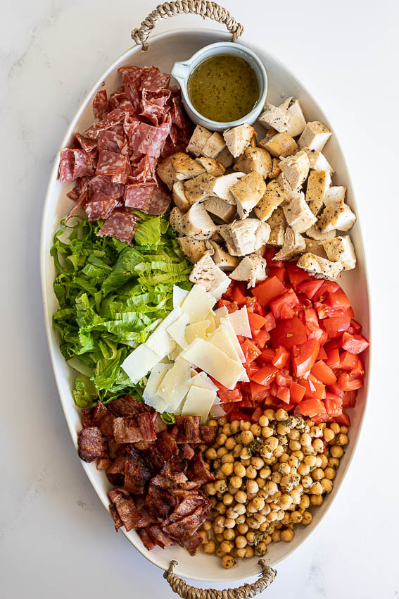 Jennifer Aniston salad with lettuce, tomatoes, chickpeas, chicken, bacon and salami.