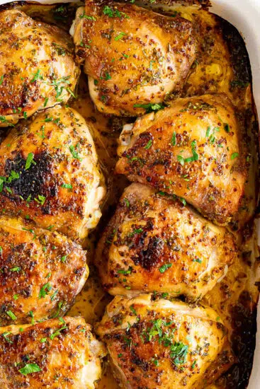 Baked honey mustard chicken thighs in baking dish.
