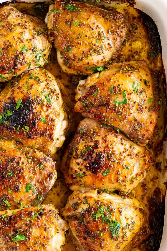 Baked honey mustard chicken thighs in baking dish.