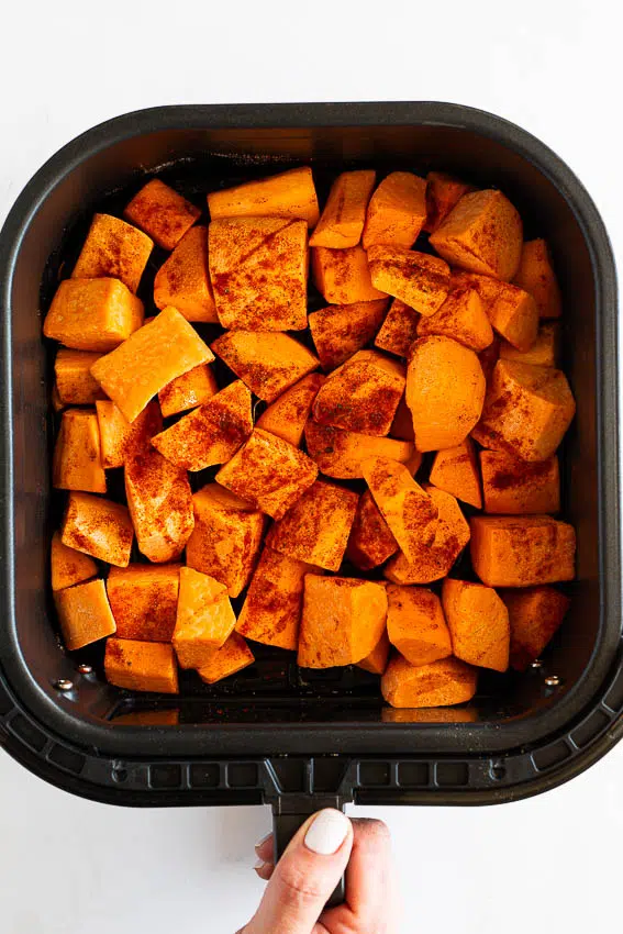 Sweet potatoes in air fryer basket