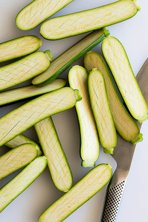 Zucchini sliced and scored.