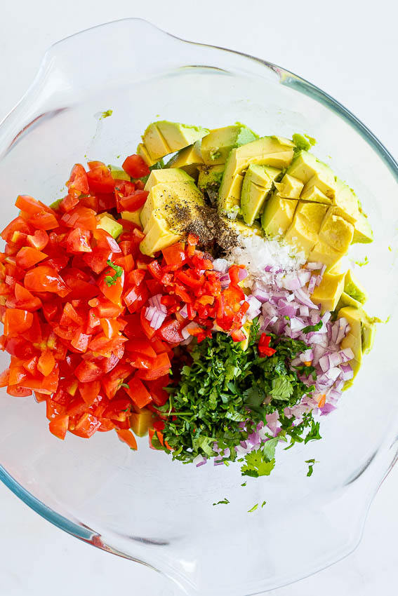 Avocado salsa ingredients in mixing bowl