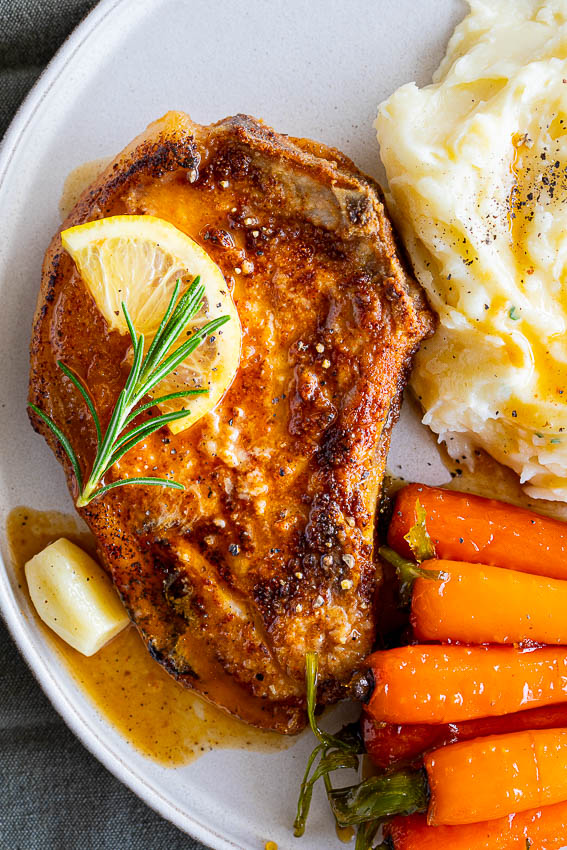 Pan Fried Pork Chops with mashed potatoes and glazed carrots