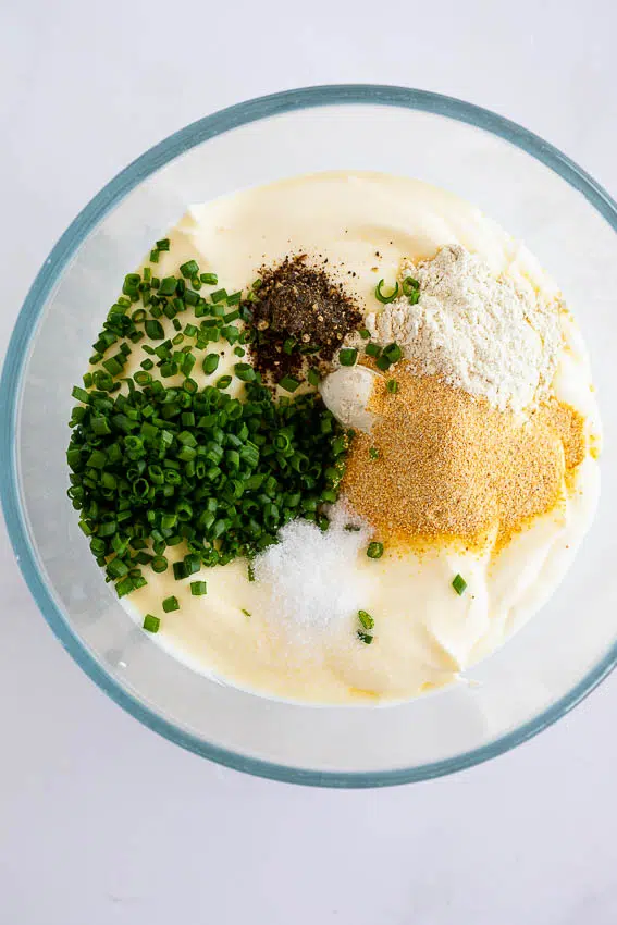 Ingredients for sour cream onion dip in bowl.