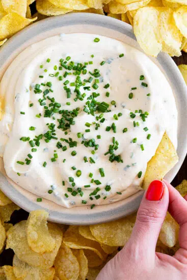 Sour cream and onion dip served with chips.