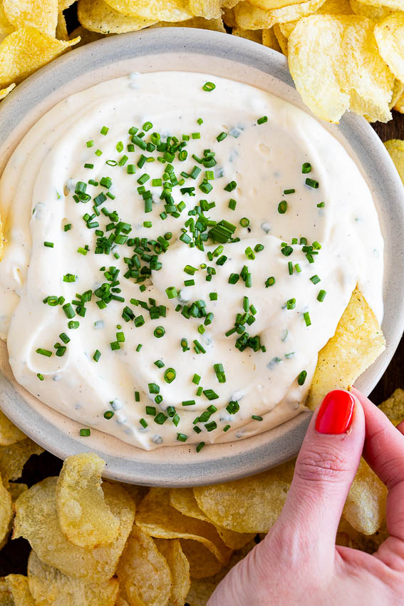 Sour cream and onion dip served with chips.