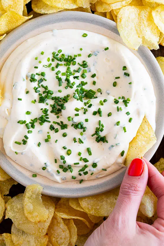 Sour cream and onion dip served with chips.