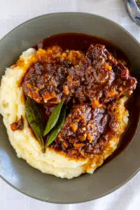 Slow Braised Oxtail with mashed potatoes in serving bowl.