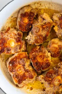 Seared oxtails in large pot.