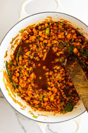 Red wine deglazing oxtail drippings.