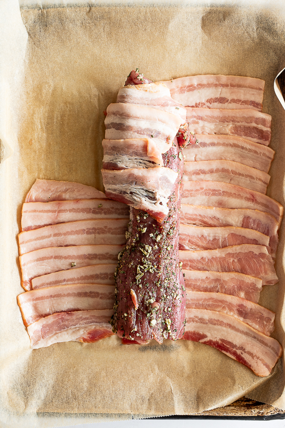Seasoned pork tenderloin wrapped in bacon.