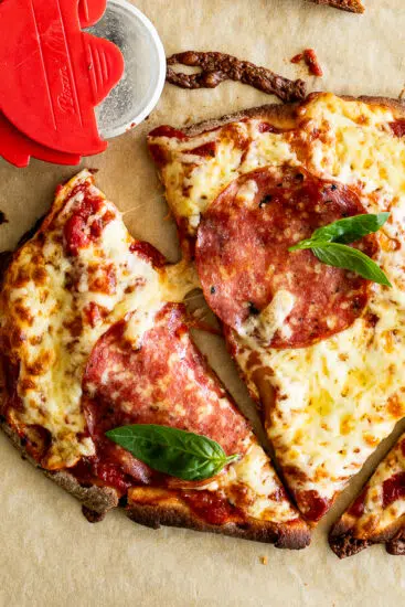 Naan Pizza topped with salami and basil.