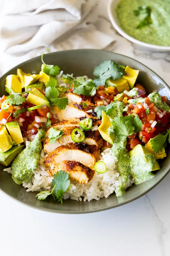 Chicken taco bowls with rice, pico de gallo and cilantro sauce.