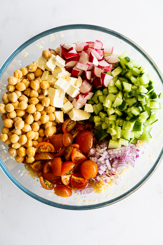 Easy Couscous salad with chickpeas, cucumber, tomatoes, feta cheese and red onion.