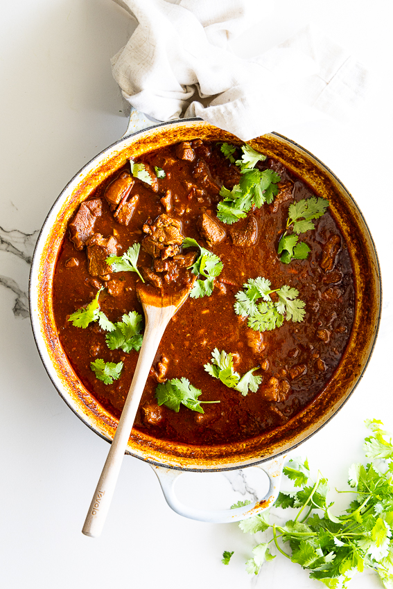 Easy lamb curry in pot garnished with cilantro.